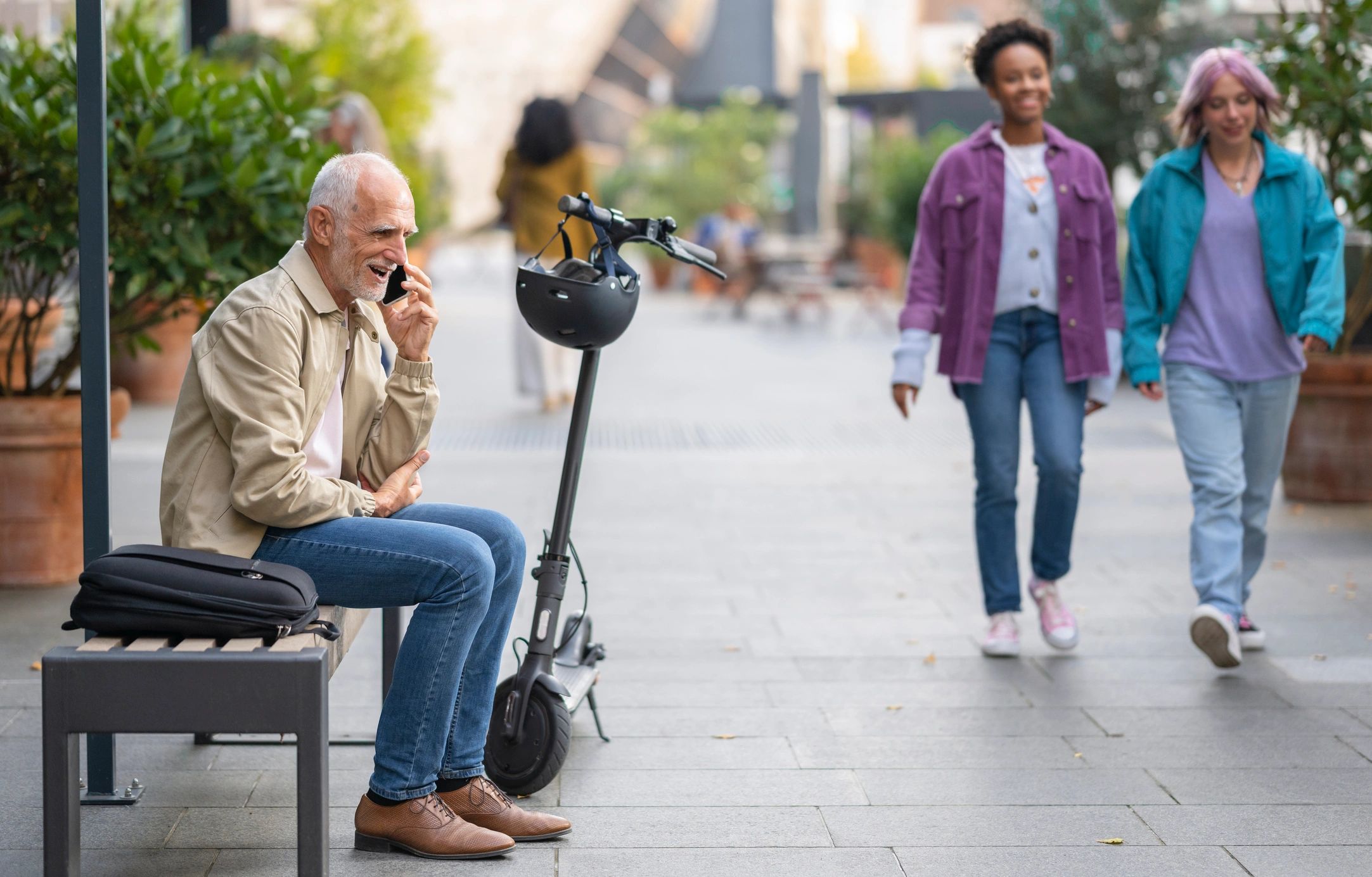 Senior adult man sitting after riding an electric scooter